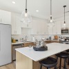 designer kitchen featuring quartz counters and soft close cabinets