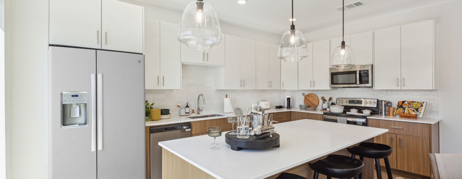designer kitchen featuring quartz counters and soft close cabinets