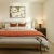 large bedroom with attached bath and large windows